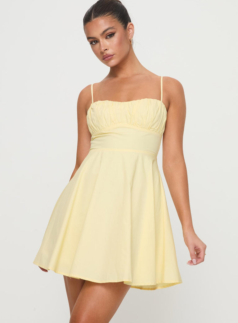 side view of model wearing Princess Polly Xantha Mini Dress Yellow Sweetheart Neckline 