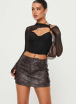   side view of model wearing Princess Polly Domenic Faux Leather Mini Skirt Washed Black Tall Mini Skirts 