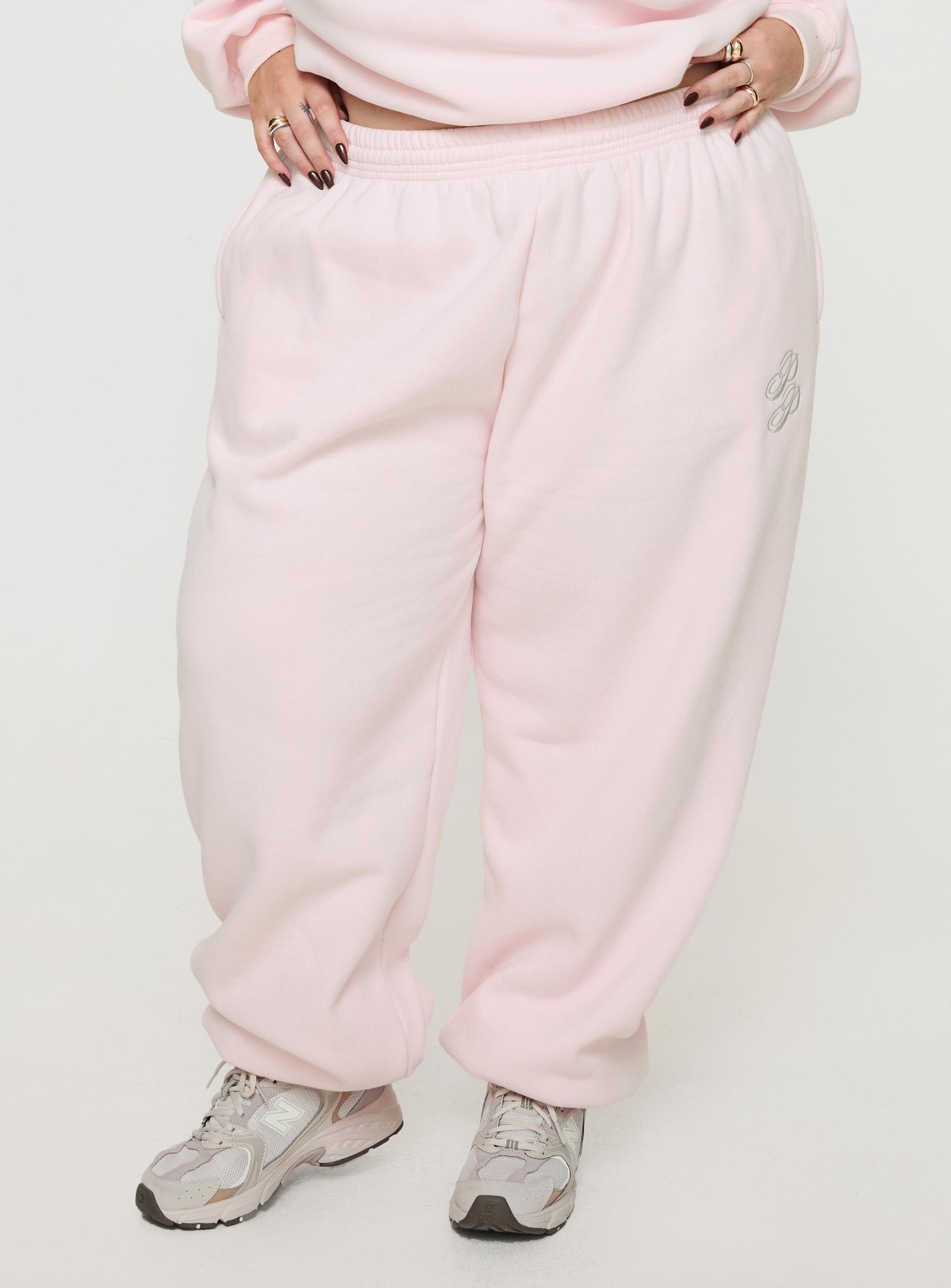 front view of model wearing Princess Polly Princess Polly Track Pants Script Baby Pink / Grey Curve 