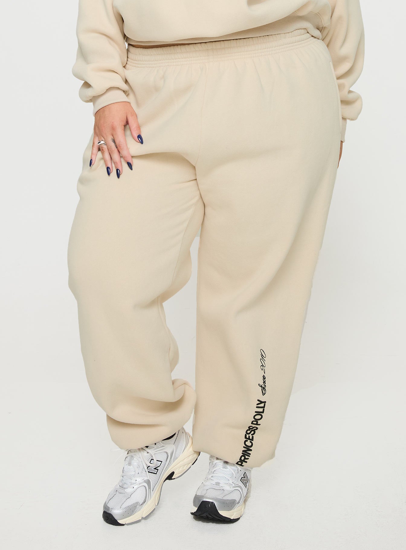 Princess polly track pants block / cursive text stone curve