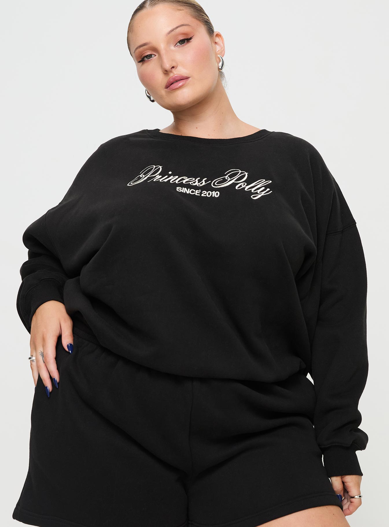 front view of model wearing Princess Polly Princess Polly Crew Neck Sweatshirt Cursive Text Black Sand Curve 