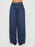 side view of model wearing Princess Polly Naylor Wide Leg Jeans Mid Blue Denim Petite Mid Rise 