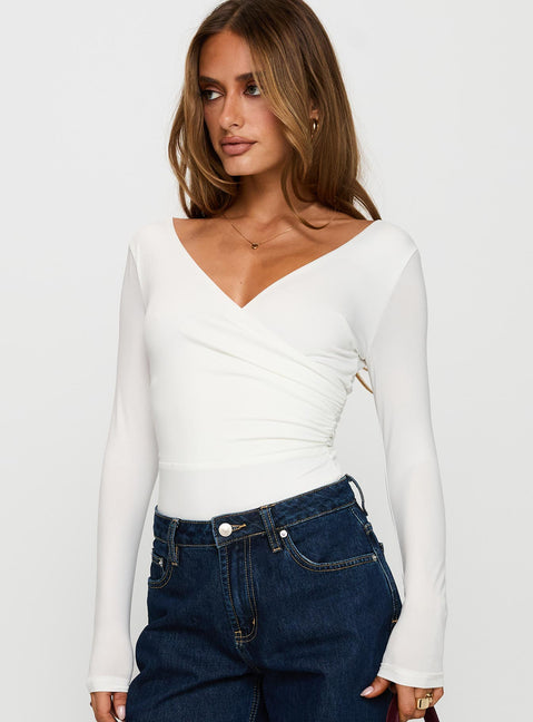 side view of model wearing Princess Polly Right Here Cross Detail Bodysuit White Long Sleeve Tops 