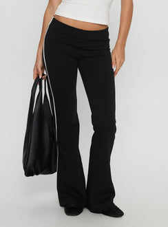side view of model wearing Princess Polly Simki Jersey Flare Pants Black Low Rise Pants 