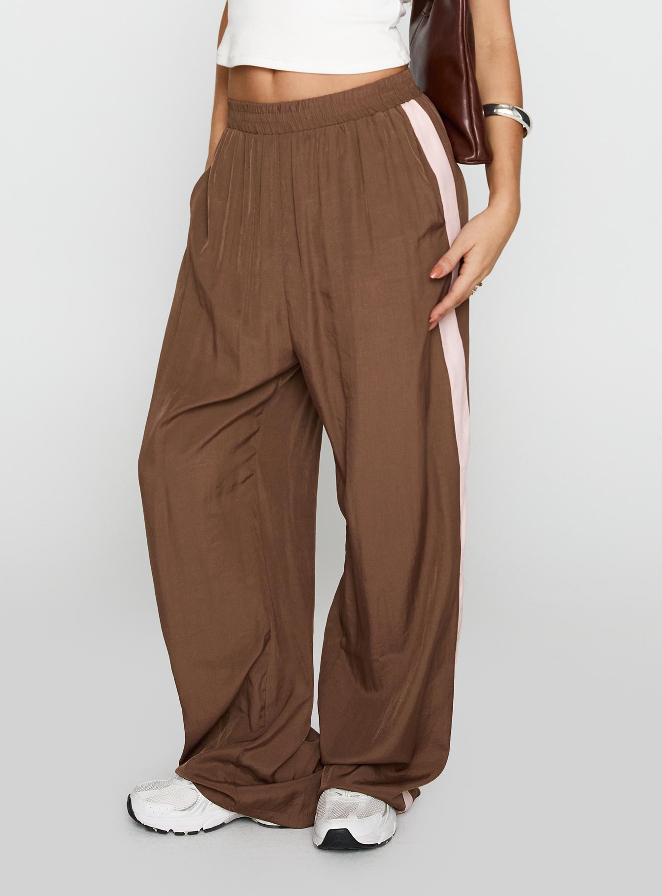 side view of model wearing Princess Polly No Doubts Track Pant Brown High Waisted Pants 