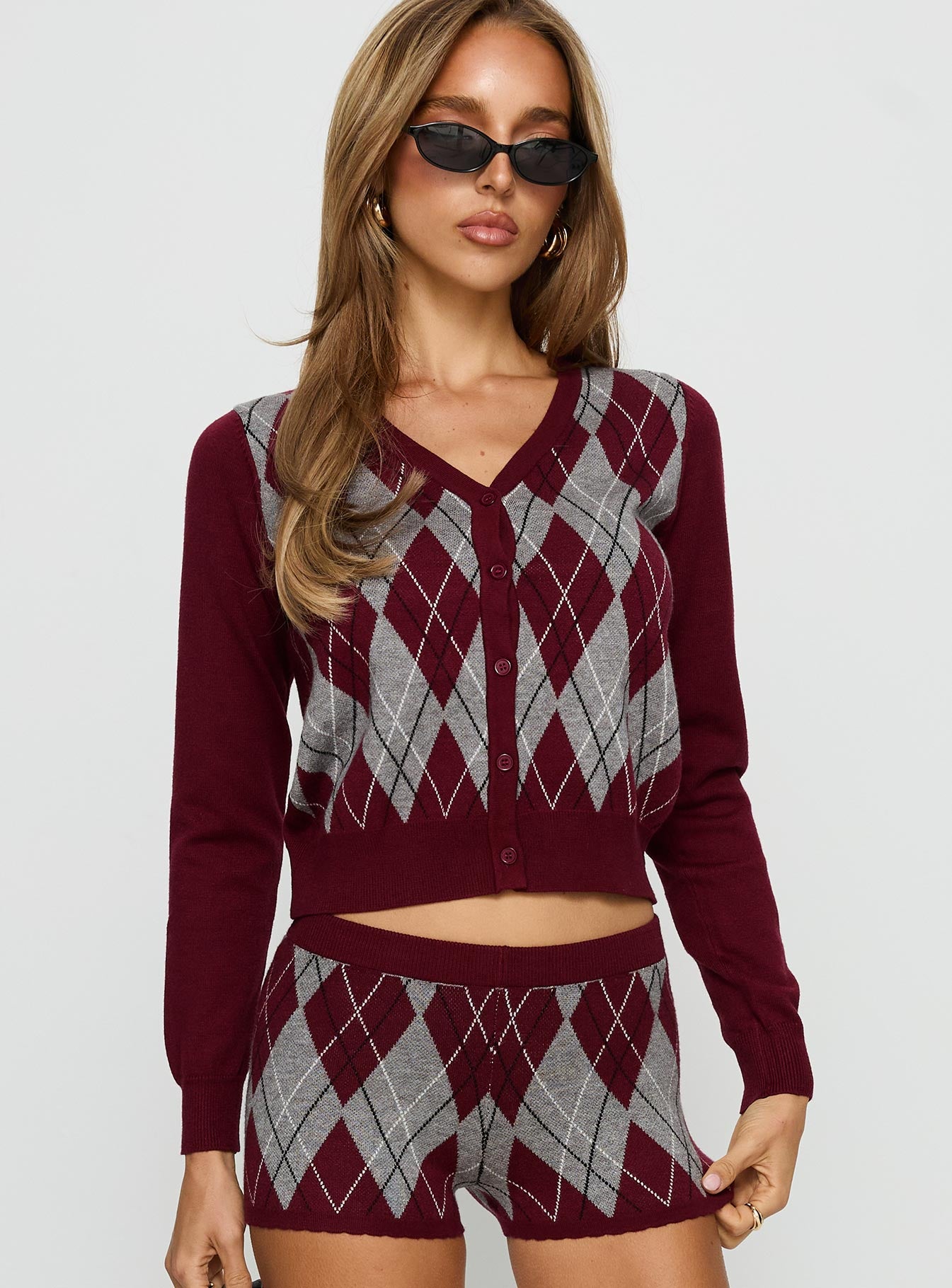 front view of model wearing Princess Polly Raiven Knit Cardigan Burgundy Argyle cropped 