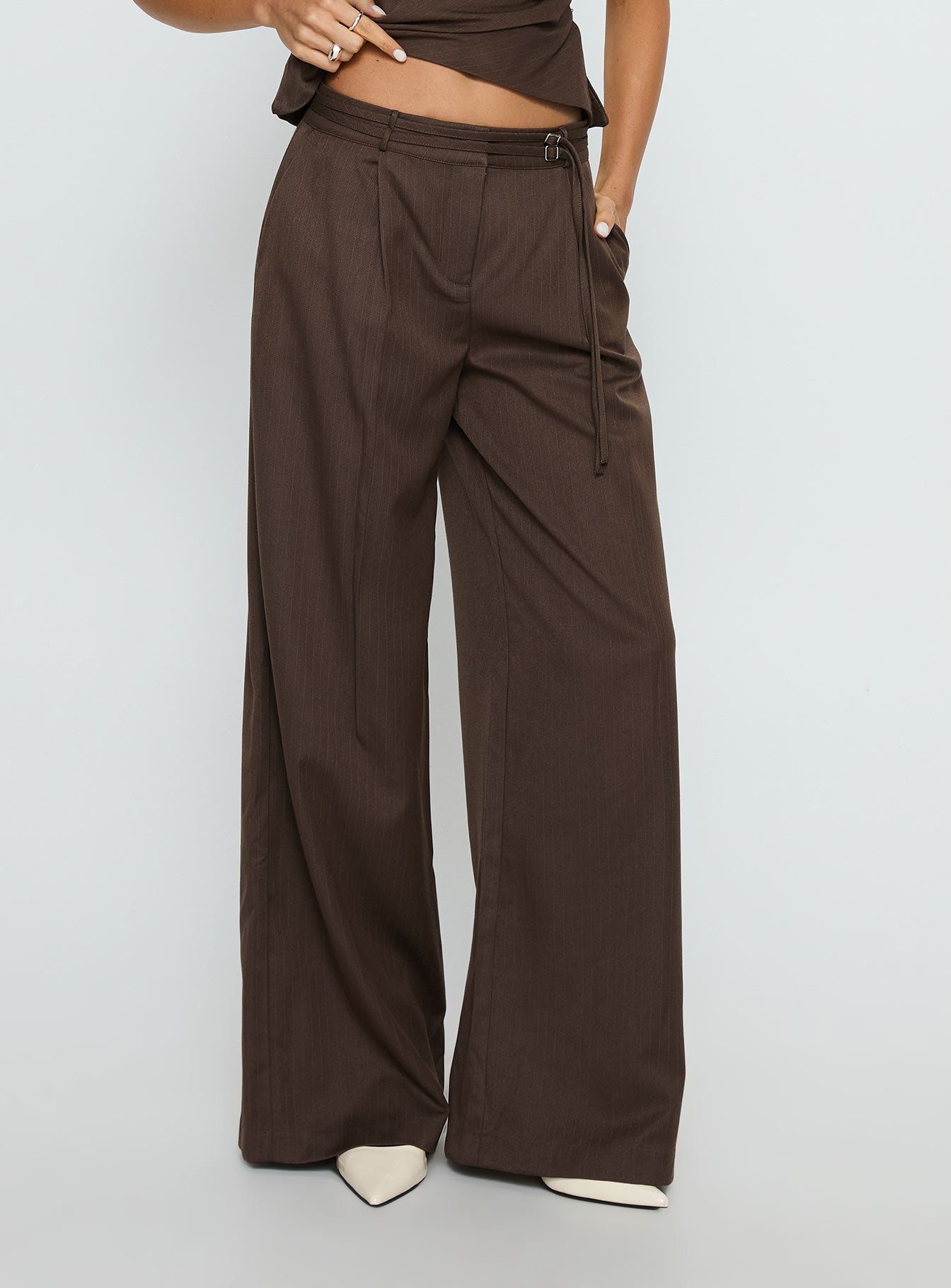 front view of model wearing Princess Polly Natilee Relaxed Tailored Pants Brown Pinstripe Low Rise Pants 