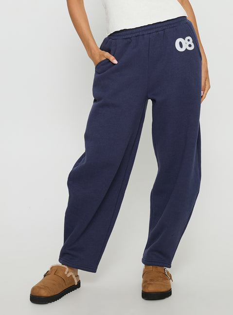 side view of model wearing Princess Polly Route 08 Barrel Track Pant Navy Mid Rise Pants 
