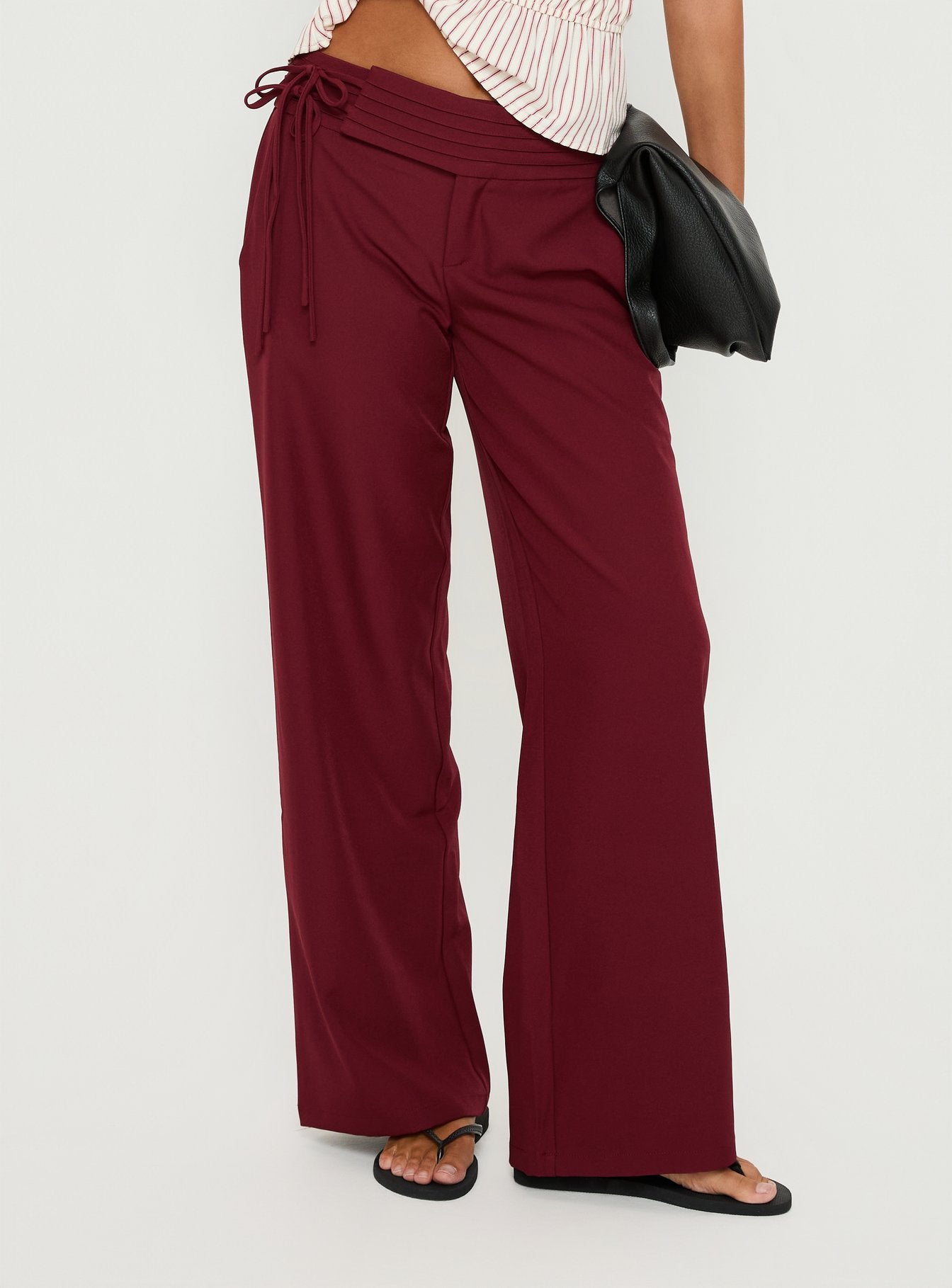 side view of model wearing Princess Polly Good Riddance Pleat Tie Slouch Pants Burgundy Mid Rise Pants 
