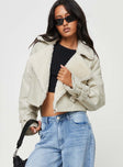 Cropped jacket Faux leather material, oversized collar, removable belts at waist and cuff, buckle fastening
