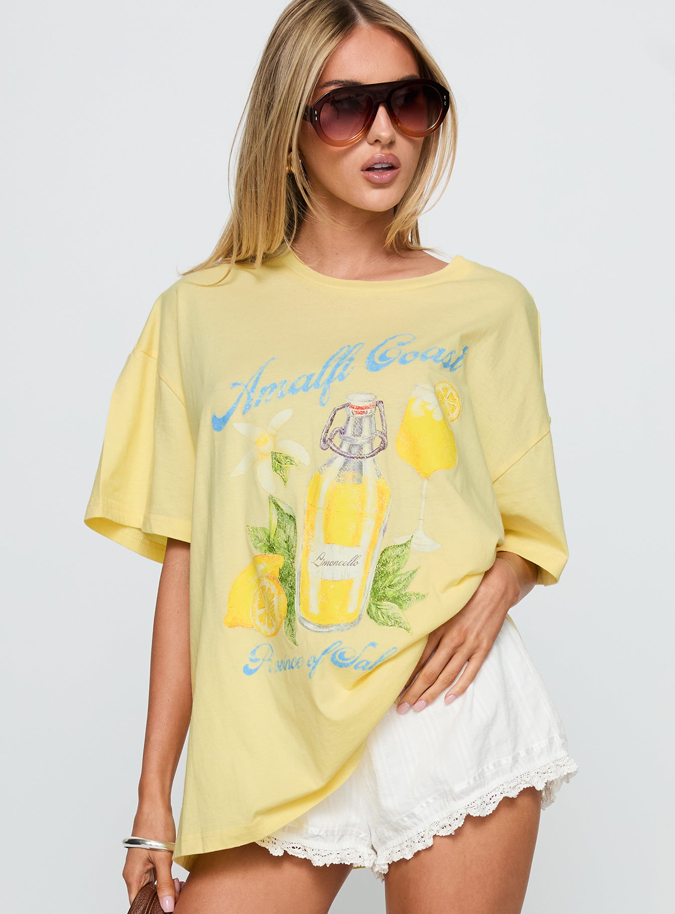 front view of model wearing Princess Polly Amalfi Coast Oversized Graphic Tee Pastel Yellow Half Sleeves Crew Neck 