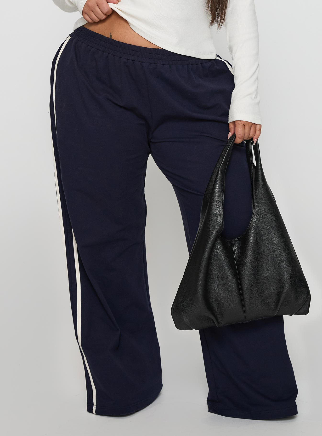 back view of model wearing Princess Polly Circuit Track Pants Navy Curve 
