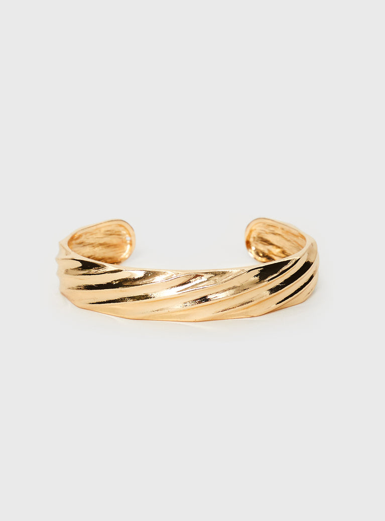 Gold toned cuff, fixed size