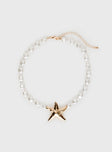Necklace Beaded pear design, gold-toned star detail, lobster clasp fastening