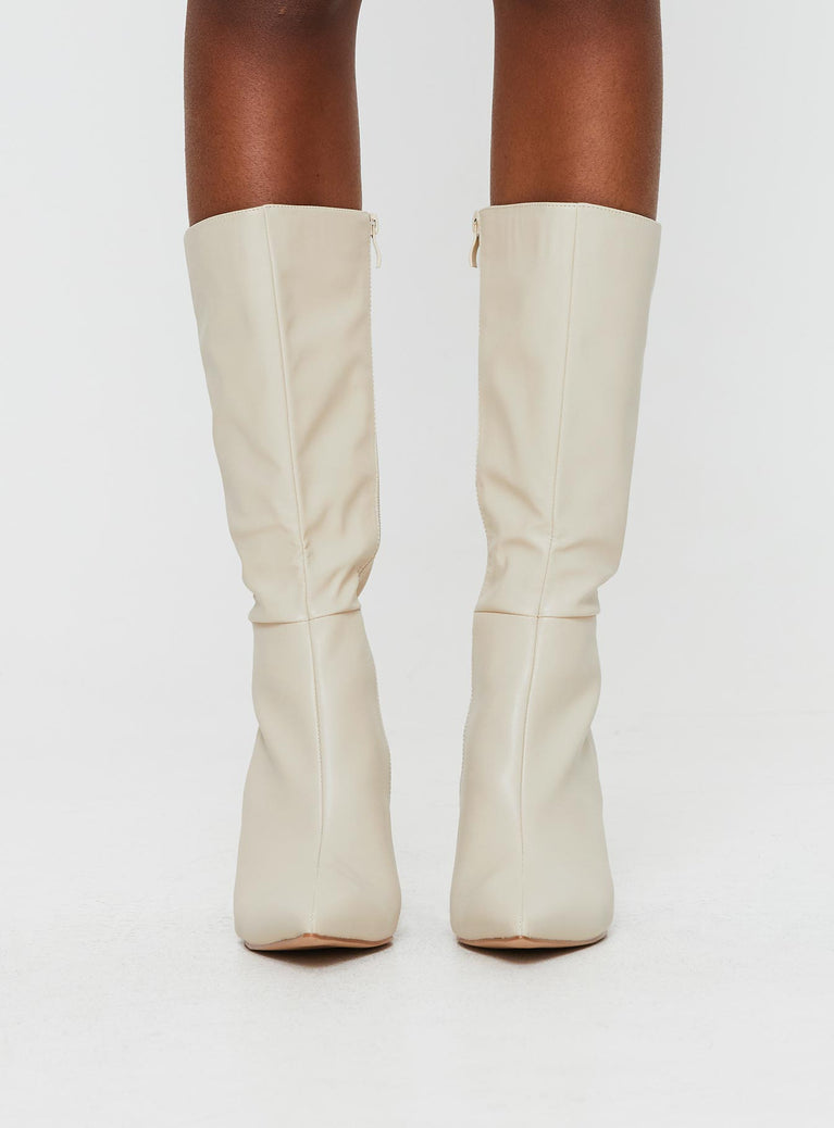 Cream Knee-high boots Faux leather material, zip fastening at inside, pointed toe, stiletto heel