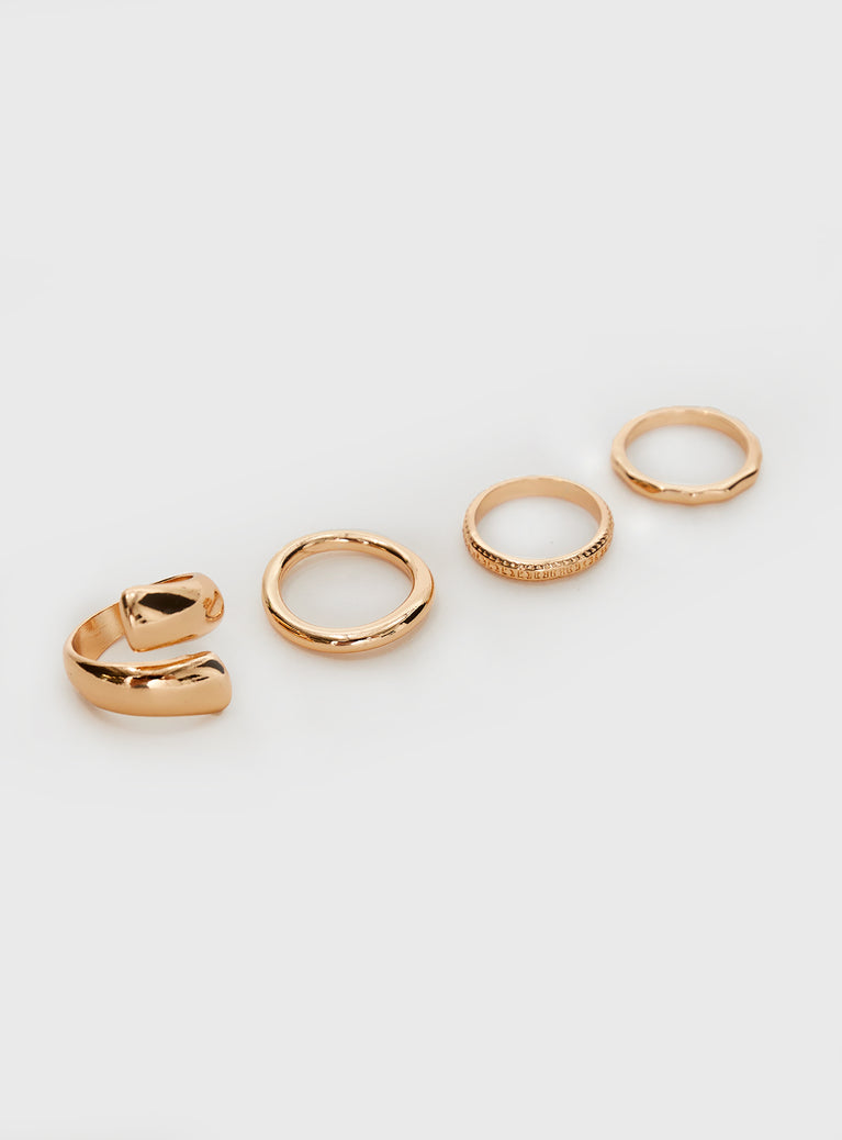 Gold-toned ring pack Four rings in pack, each ring uniquely different 
