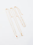 Gold-toned necklace set Pack of three, drop charms, lobster clasp fastening