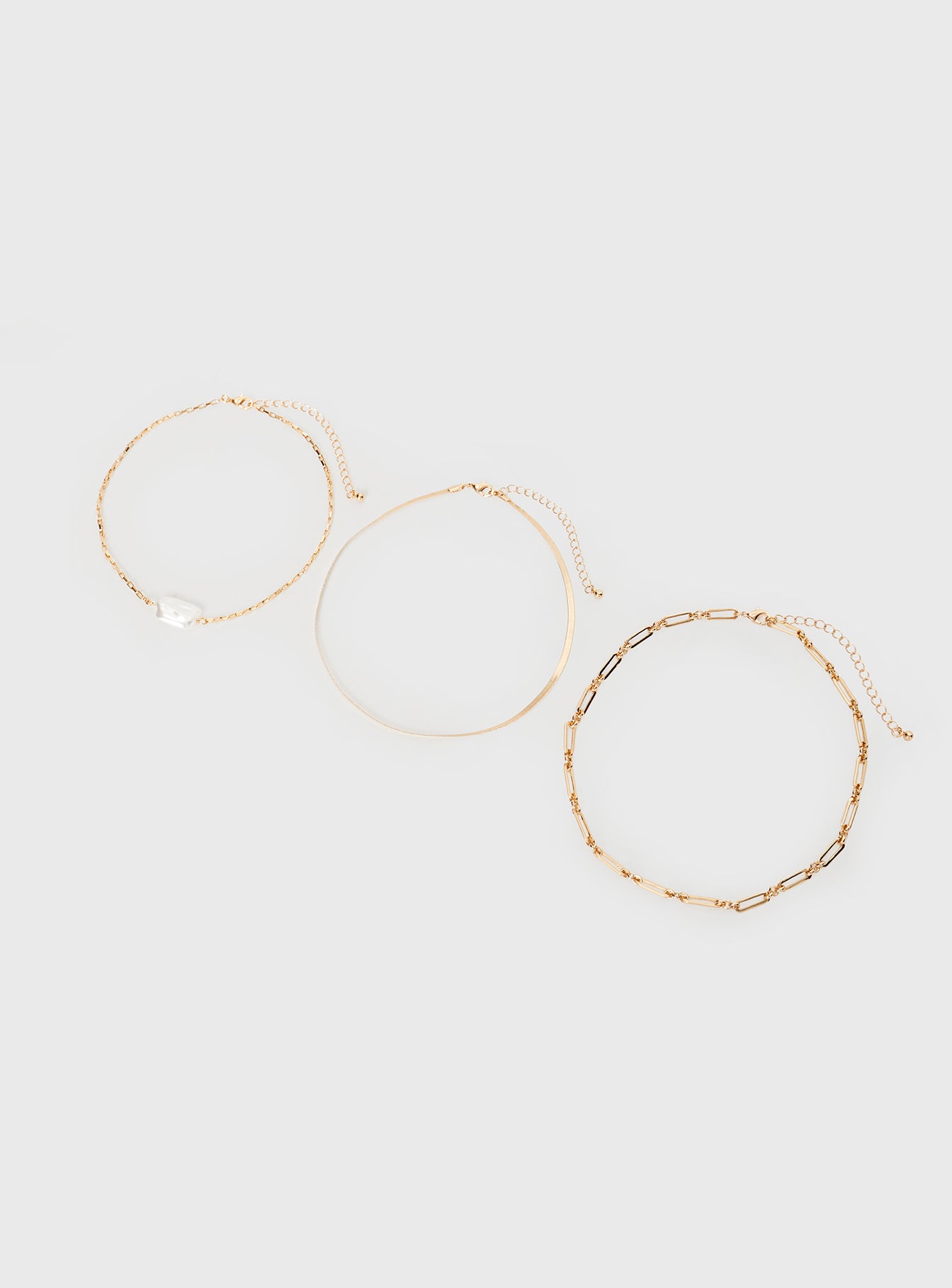 Gold-toned necklace Pack of three seperate chains, lobster clasp fastening, pearl detail