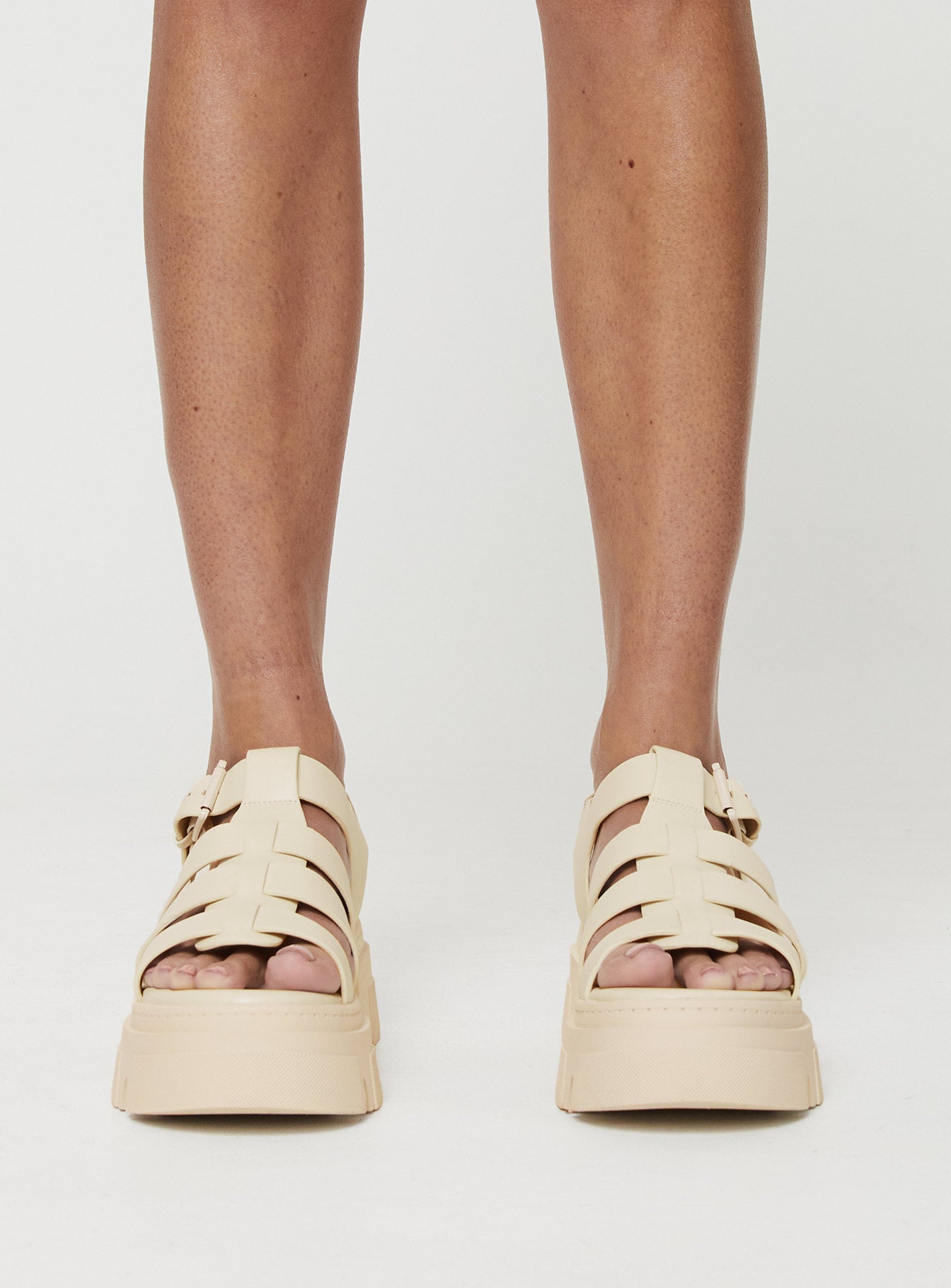 Strappy sandals Rounded toe, strappy upper, buckle fastening at ankle, platform base, treaded sole