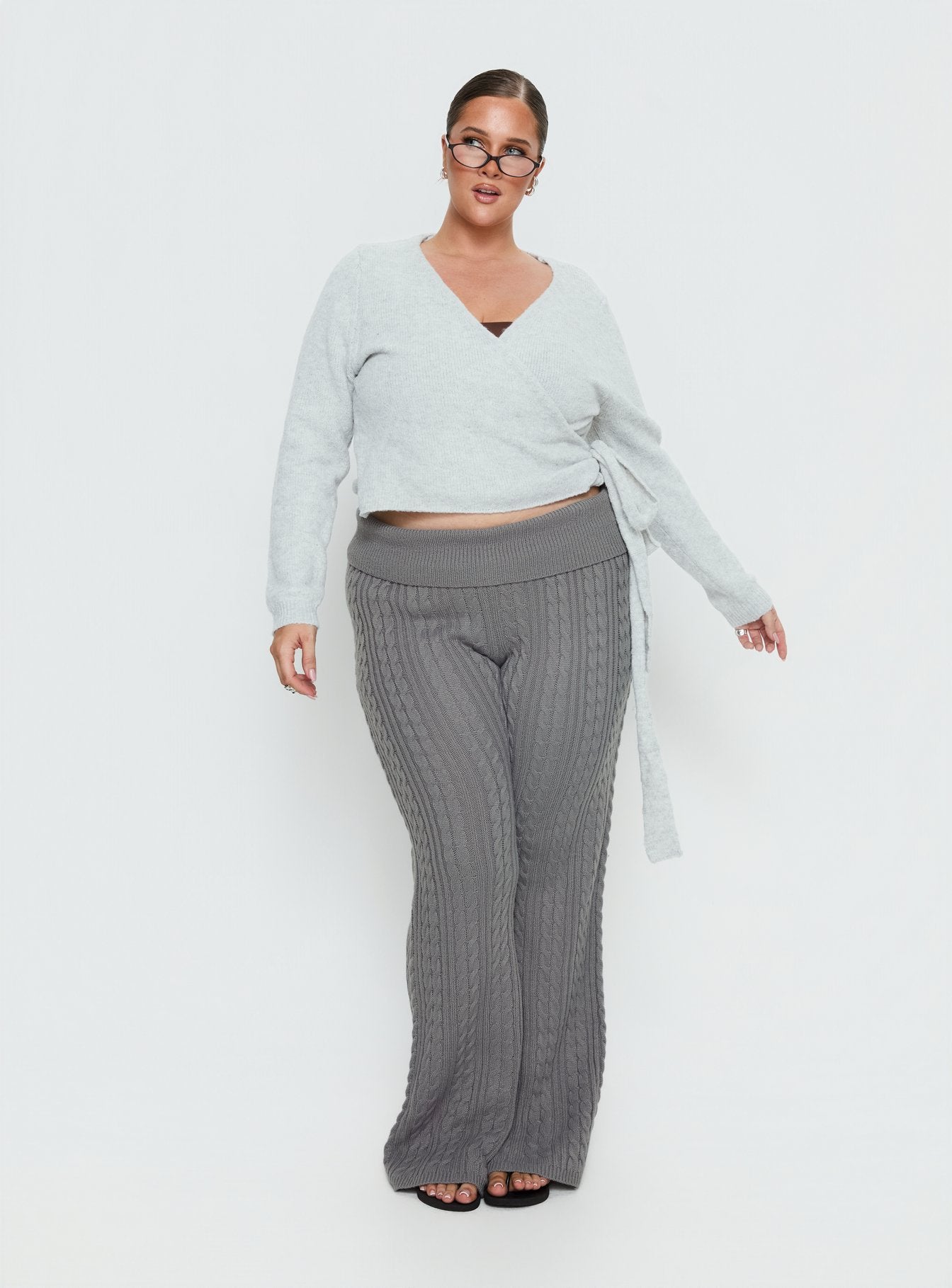side view of model wearing Princess Polly Baleigh Cable Knit Foldover Pants Grey Curve High Rise Pants 