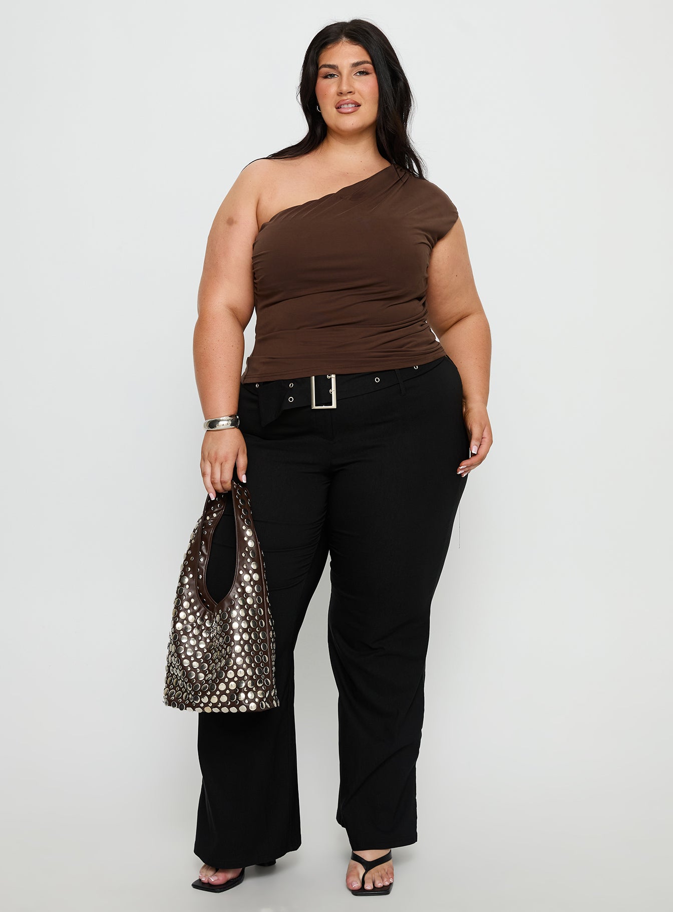 side view of model wearing Princess Polly Kortnee Eyelet Detail Flare Leg Pants Black Curve Mid Rise Pants 