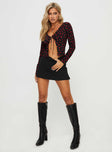 side view of model wearing Princess Polly Afia Long Sleeve Top Black / Red Full Sleeves Plunger 