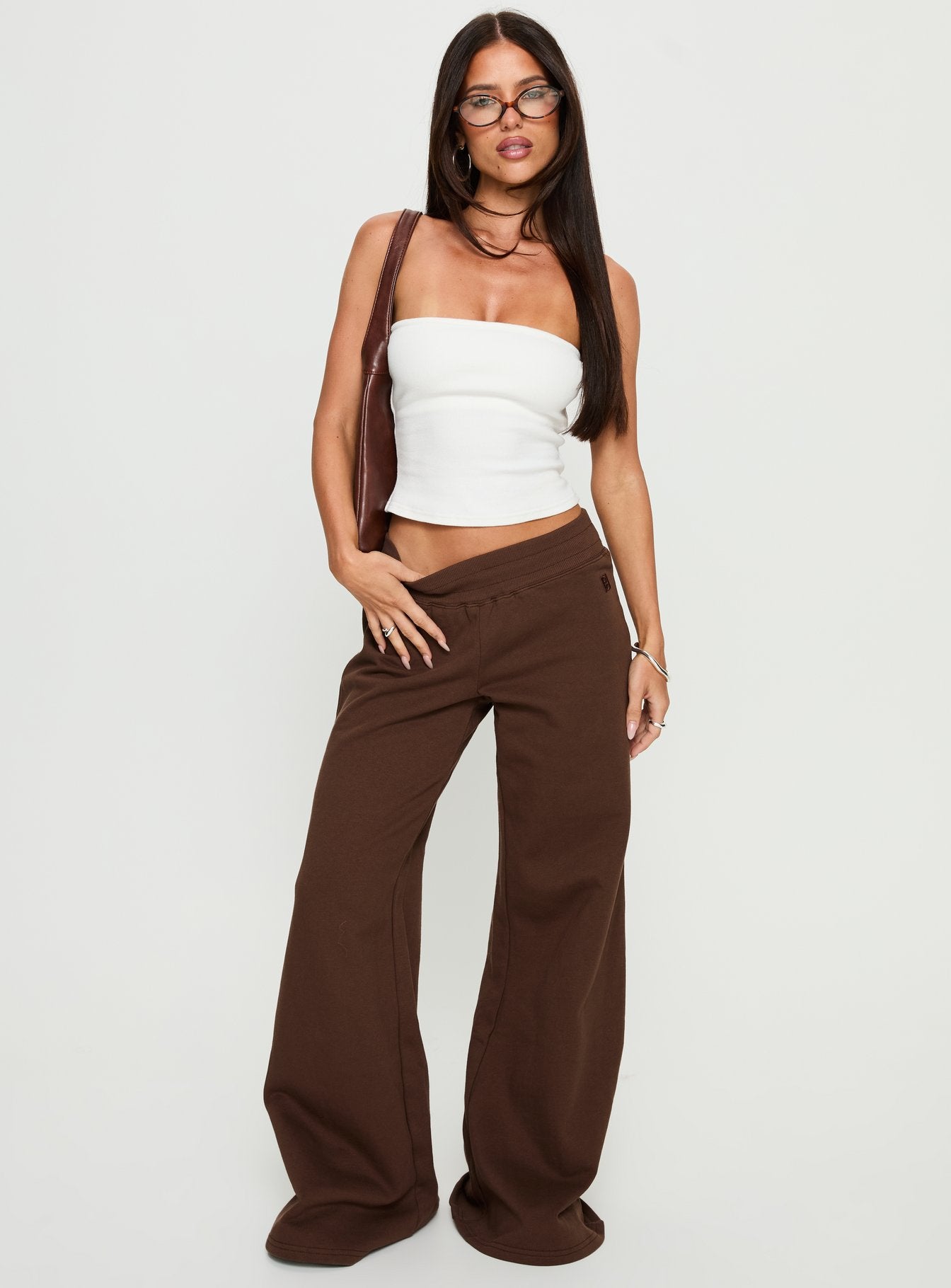 front view of model wearing Princess Polly Summits Flared Track Pants Chocolate High Rise Pants 