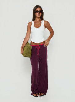 Crafted from plum and crimson, the Jessika Ultra Low Pants womens-regular-pants with low-rise waist on-body view of model wearing