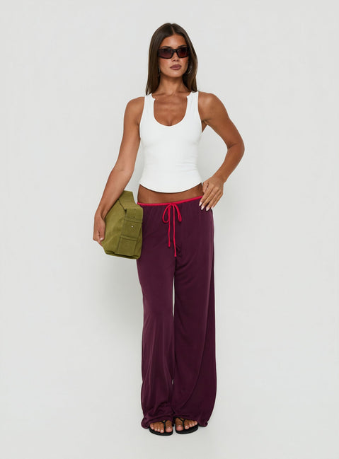 Crafted from plum and crimson, the Jessika Ultra Low Pants womens-regular-pants with low-rise waist on-body view of model wearing