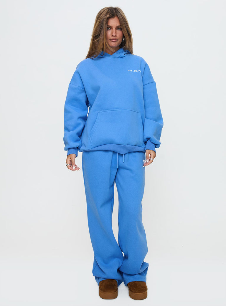 side view of model wearing Princess Polly Princess Polly Hooded Sweatshirt Bubble Text Blue / White Long 