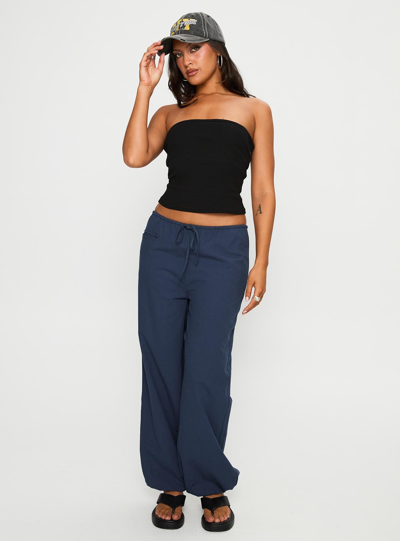 side view of model wearing Princess Polly Zodie Low Waist Pants Navy Low Rise Pants 