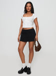 front view of model wearing Princess Polly Sora Skort Black High Waisted Shorts 