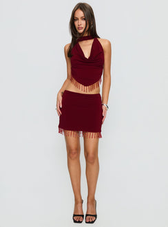   side view of model wearing Princess Polly Ginah Bead Tassel Mini Skirt Red Mini Skirts 