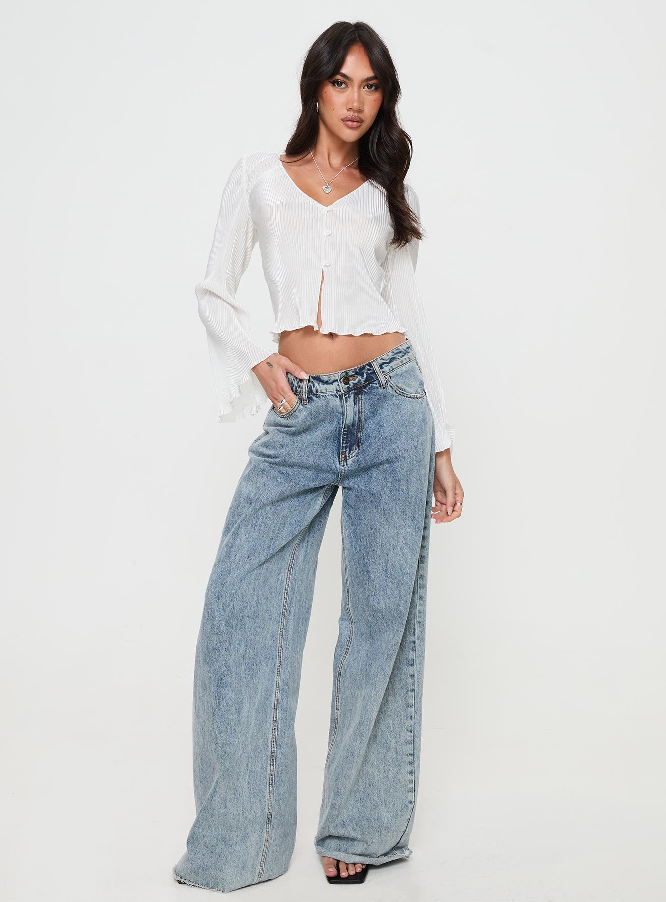 side view of model wearing Princess Polly Collis Long Sleeve Top Cream Full Sleeves V-Neck 