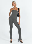 Strapless jumpsuit Inner silicone strip at bust Invisible zip fastening at back Split at cuff Slim leg Fully lined