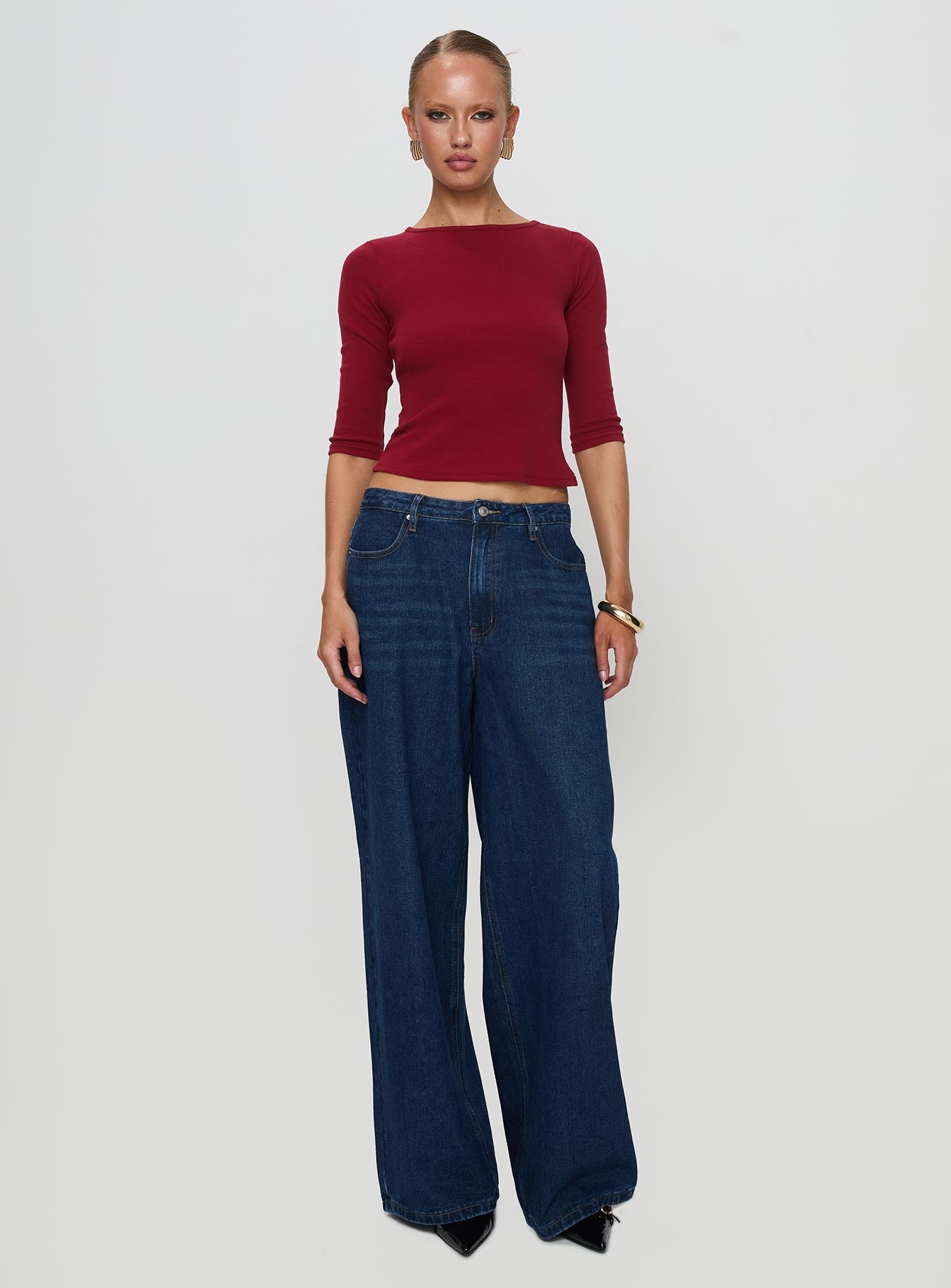 side view of model wearing Princess Polly Elaia 3/4 Sleeve Top Red Three Fourth Sleeves Crew Neck 