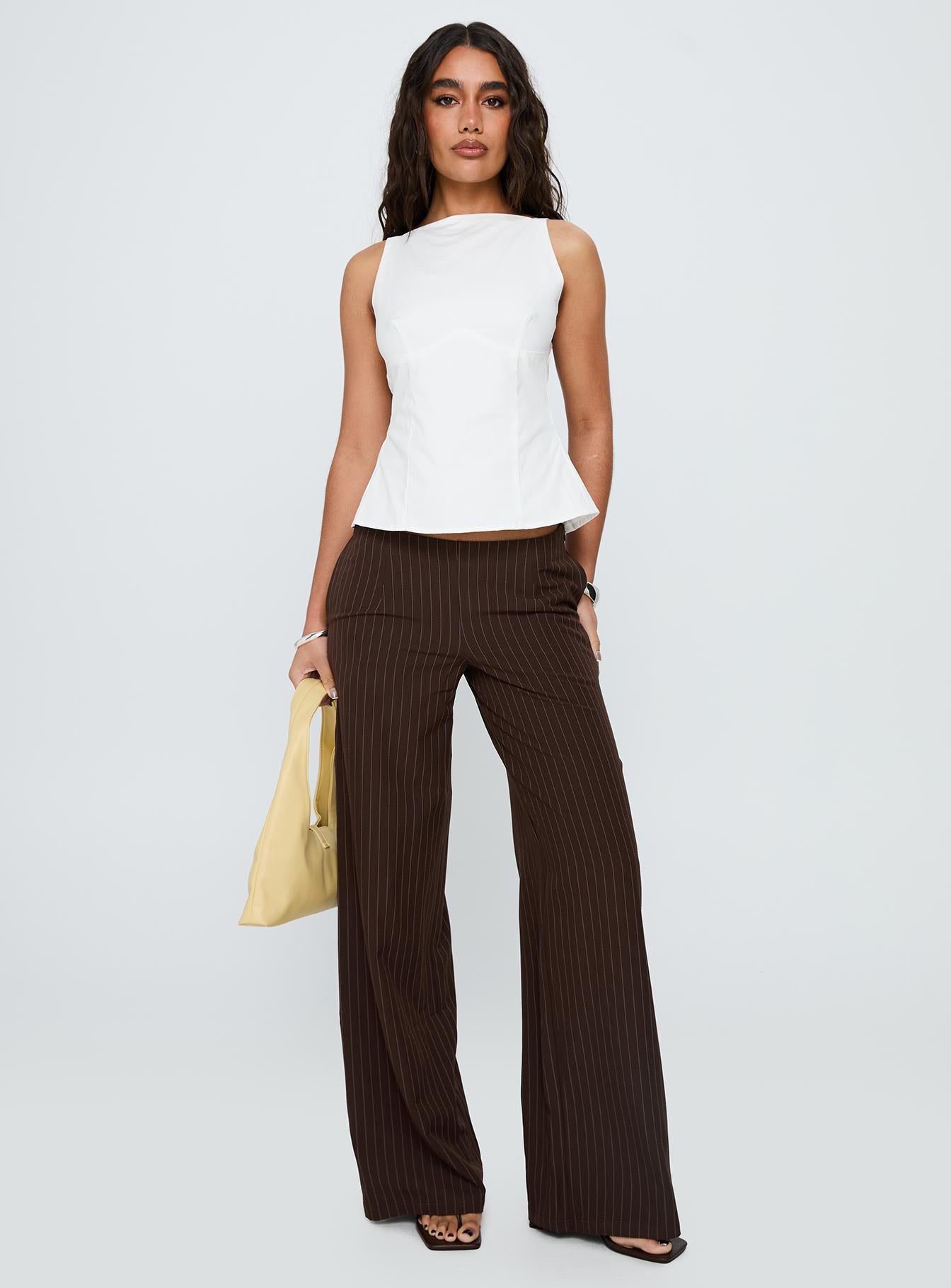 front view of model wearing Princess Polly Khane Low Rise Wide Leg Pant Brown Pinstripe Low Rise Pants 