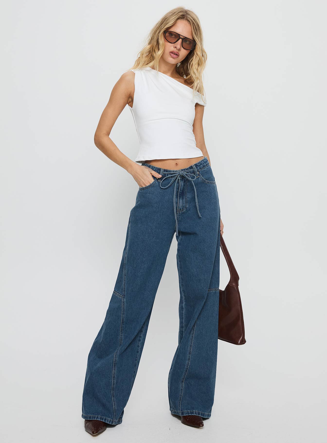 front view of model wearing Princess Polly Bruiser Mid Rise Wide Leg Jeans Mid Blue Wash Mid Rise Jeans 