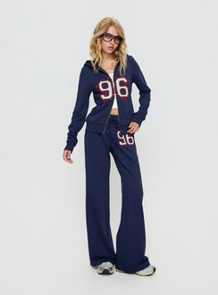 side view of model wearing Princess Polly Kari Distressed Patch Track Pant Navy Multi High Rise Pants 