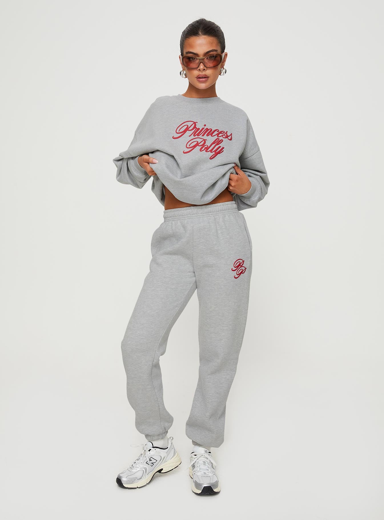 front view of model wearing Princess Polly Princess Polly Track Pants Cursive Text Grey Marle/ Red High Waisted Pants 