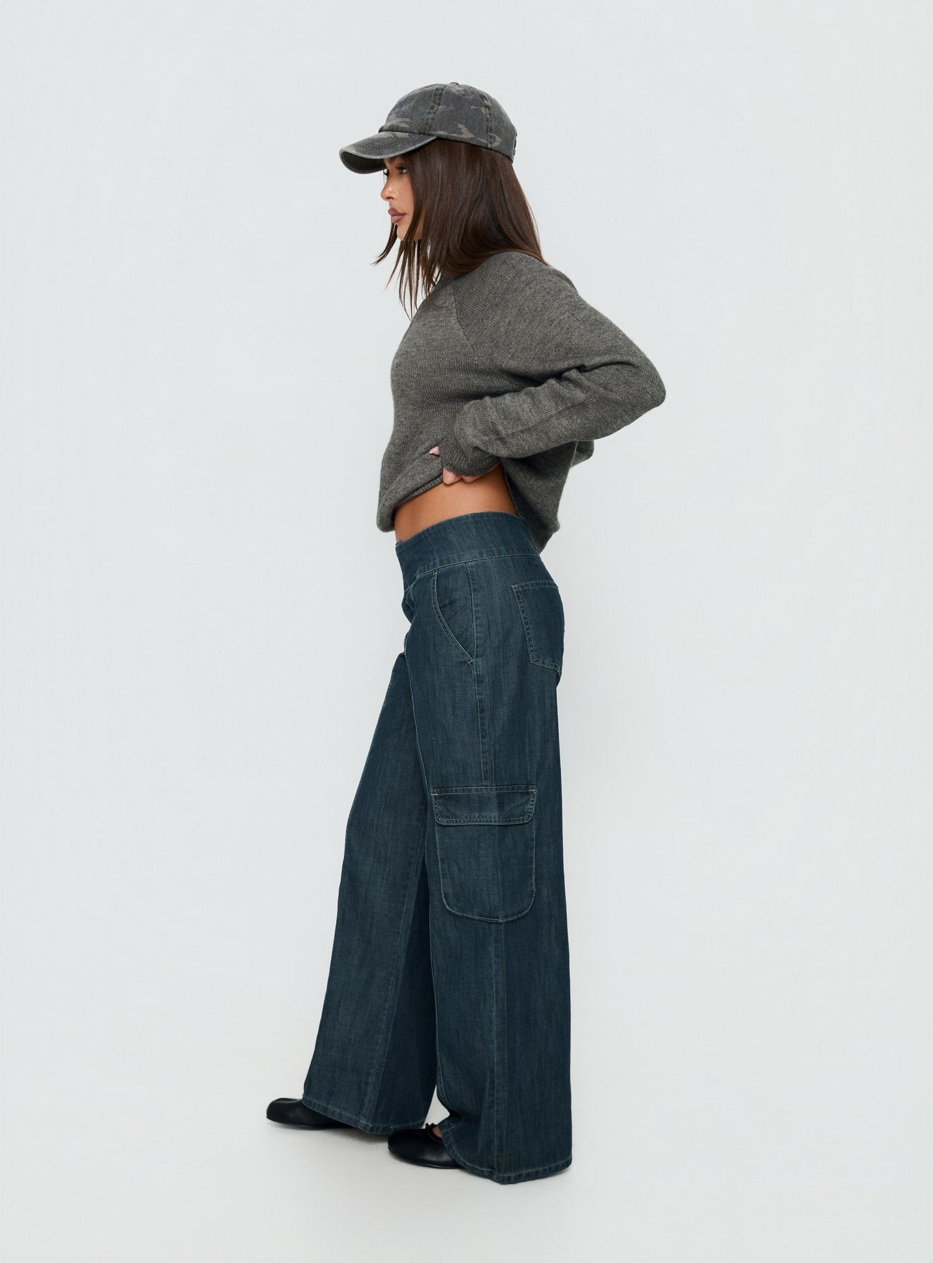 Crafted with the Nikoletta Mid Rise Wide Leg Cargo Jeans Dark Blue Wash in womens-jeans with mid-rise side view of model wearing