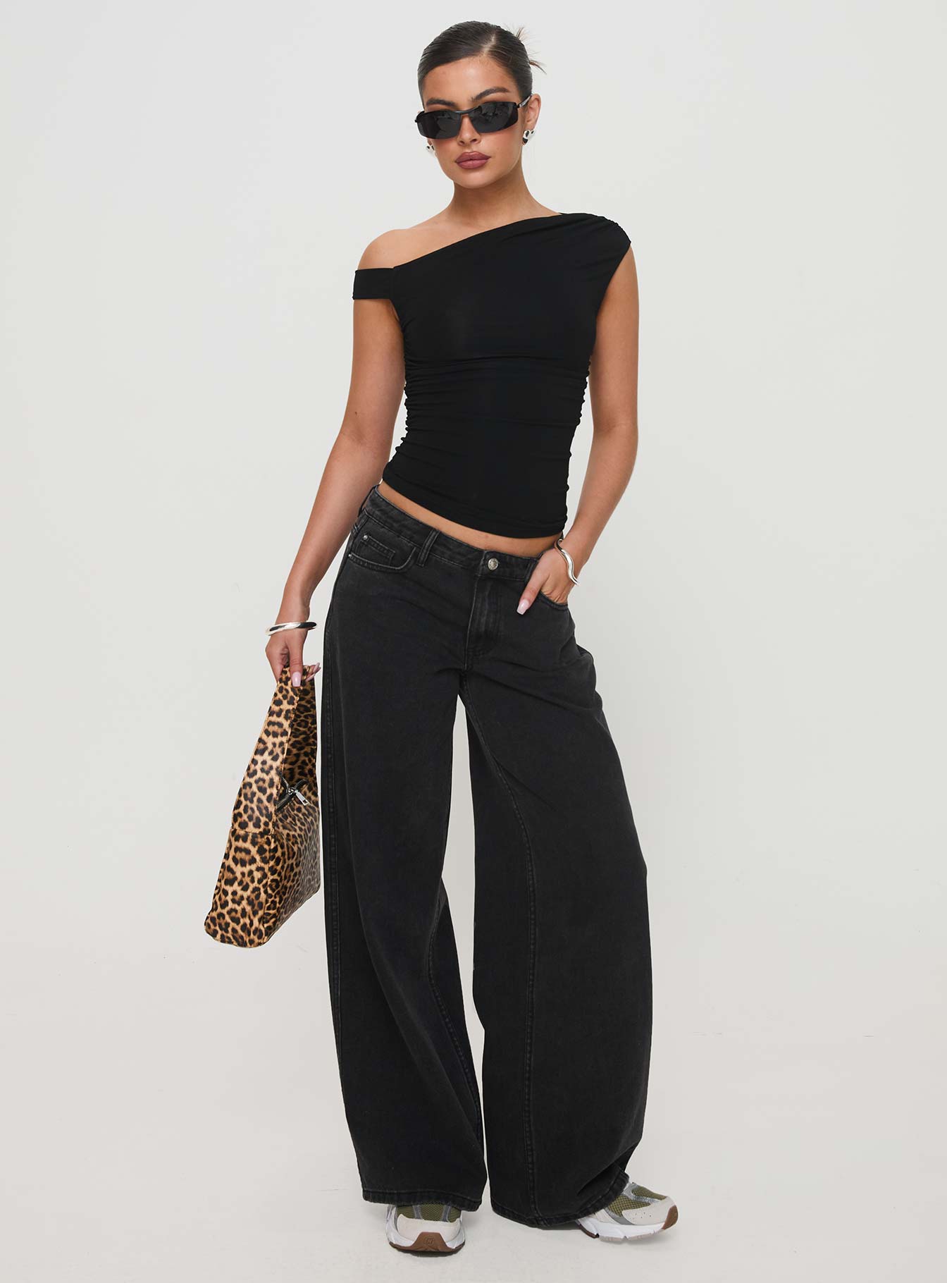 side view of model wearing Princess Polly Ramos Low Rise Denim Jeans Washed Black Tall Mid Rise 