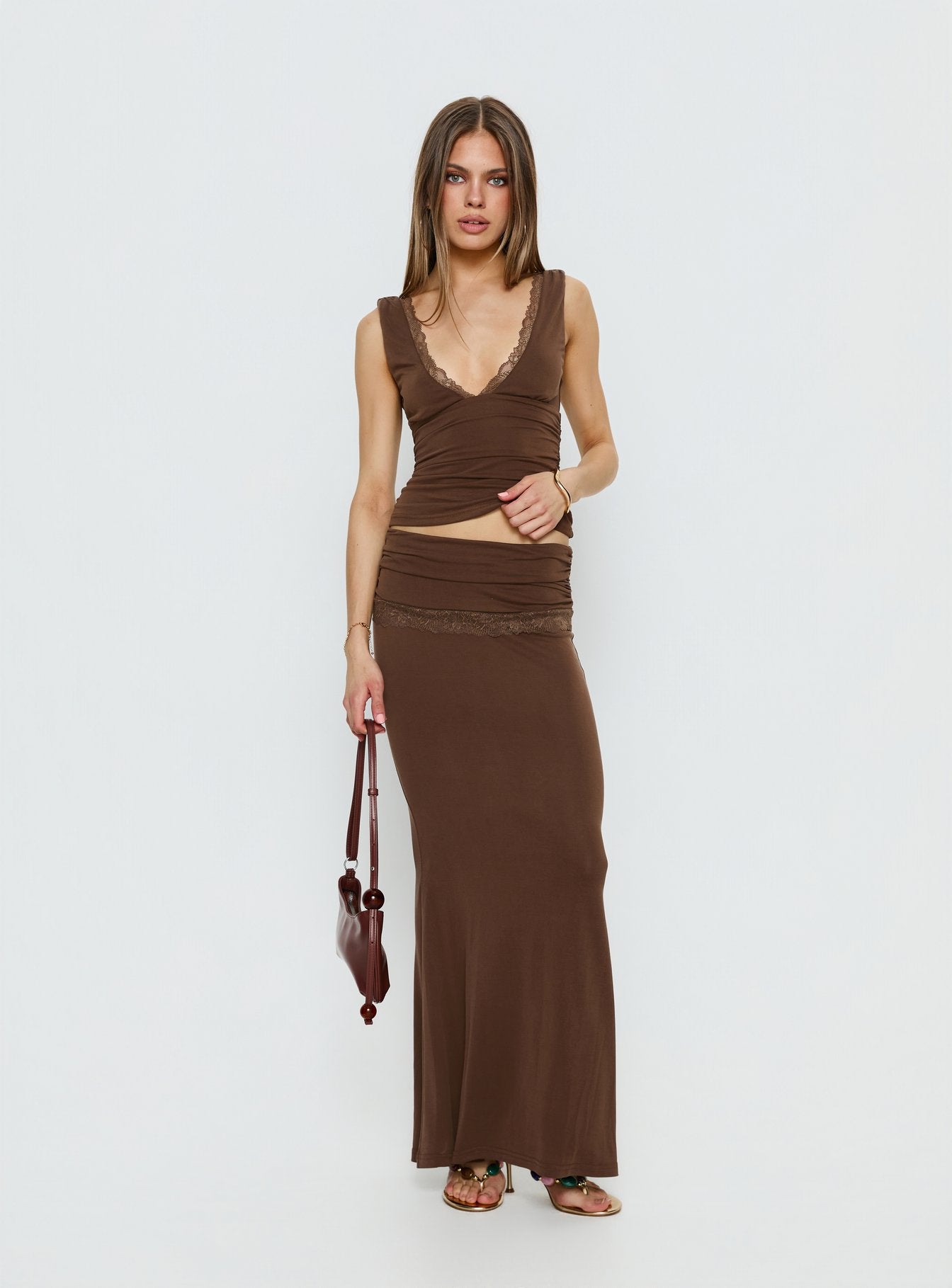   side view of model wearing Princess Polly Zespri Jersey Maxi Skirt Brown Maxi Skirts 