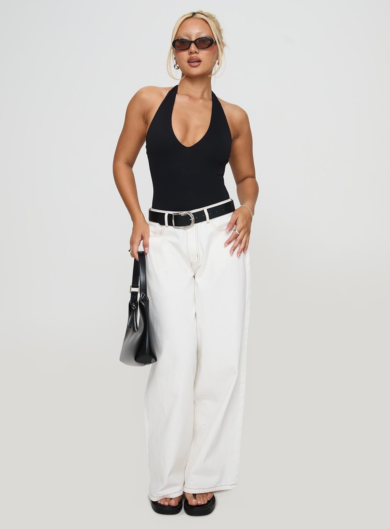 side view of model wearing Princess Polly Someone New Halter Bodysuit Black Sleeveless 