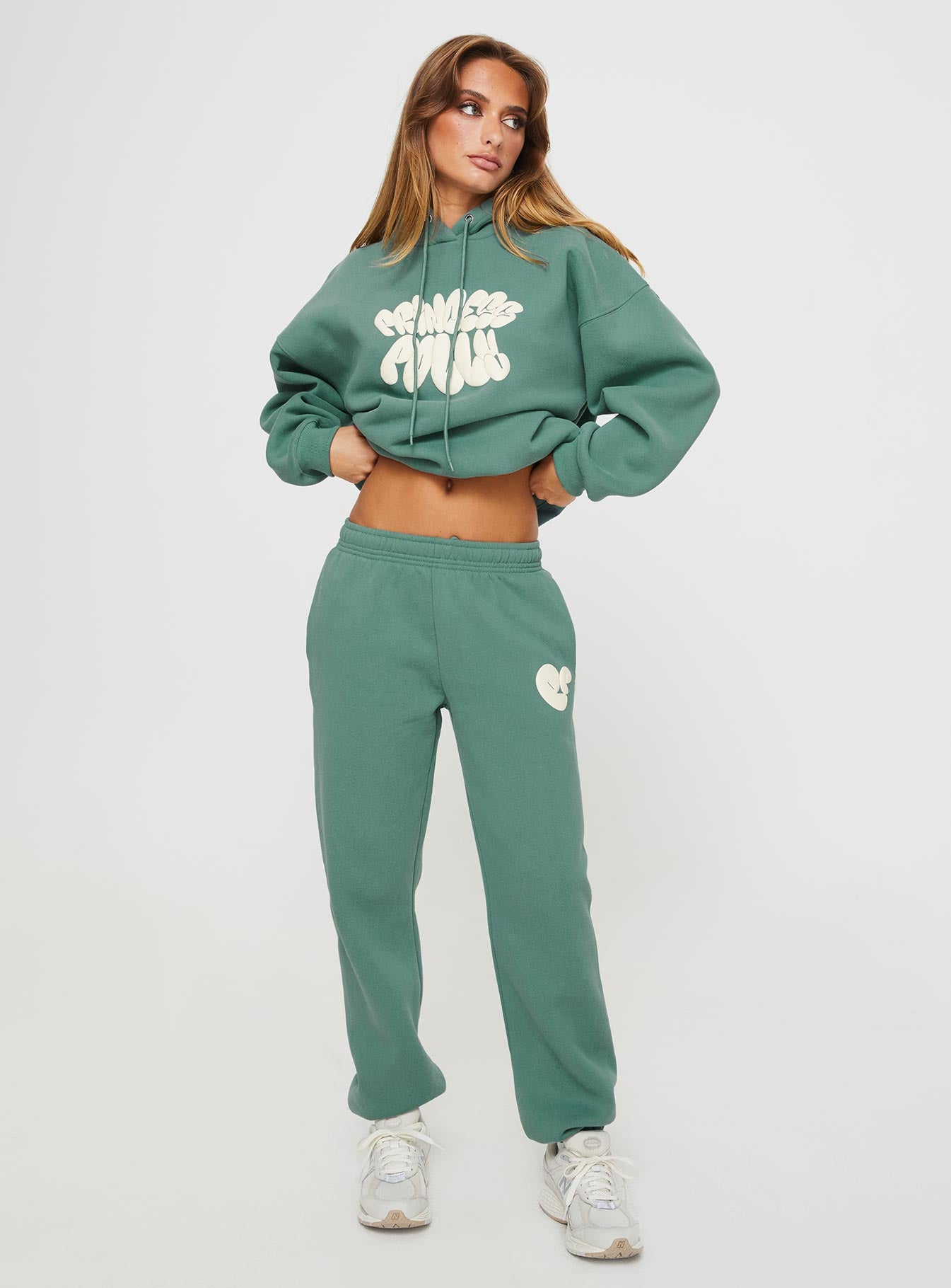 front view of model wearing Princess Polly Princess Polly Track Pants Bubble Text Sage / Eggshell Mid Rise 
