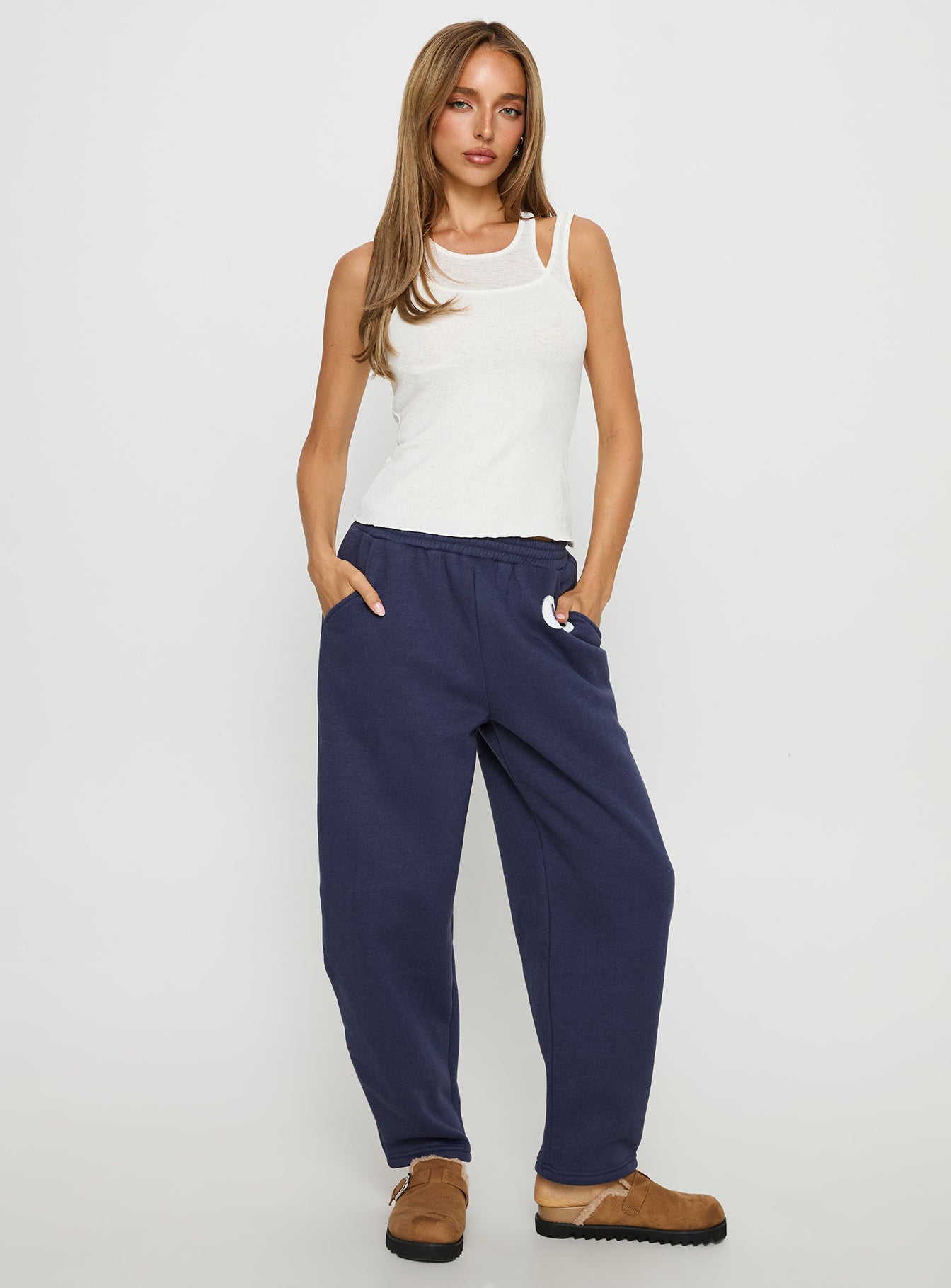 front view of model wearing Princess Polly Route 08 Barrel Track Pant Navy Mid Rise Pants 