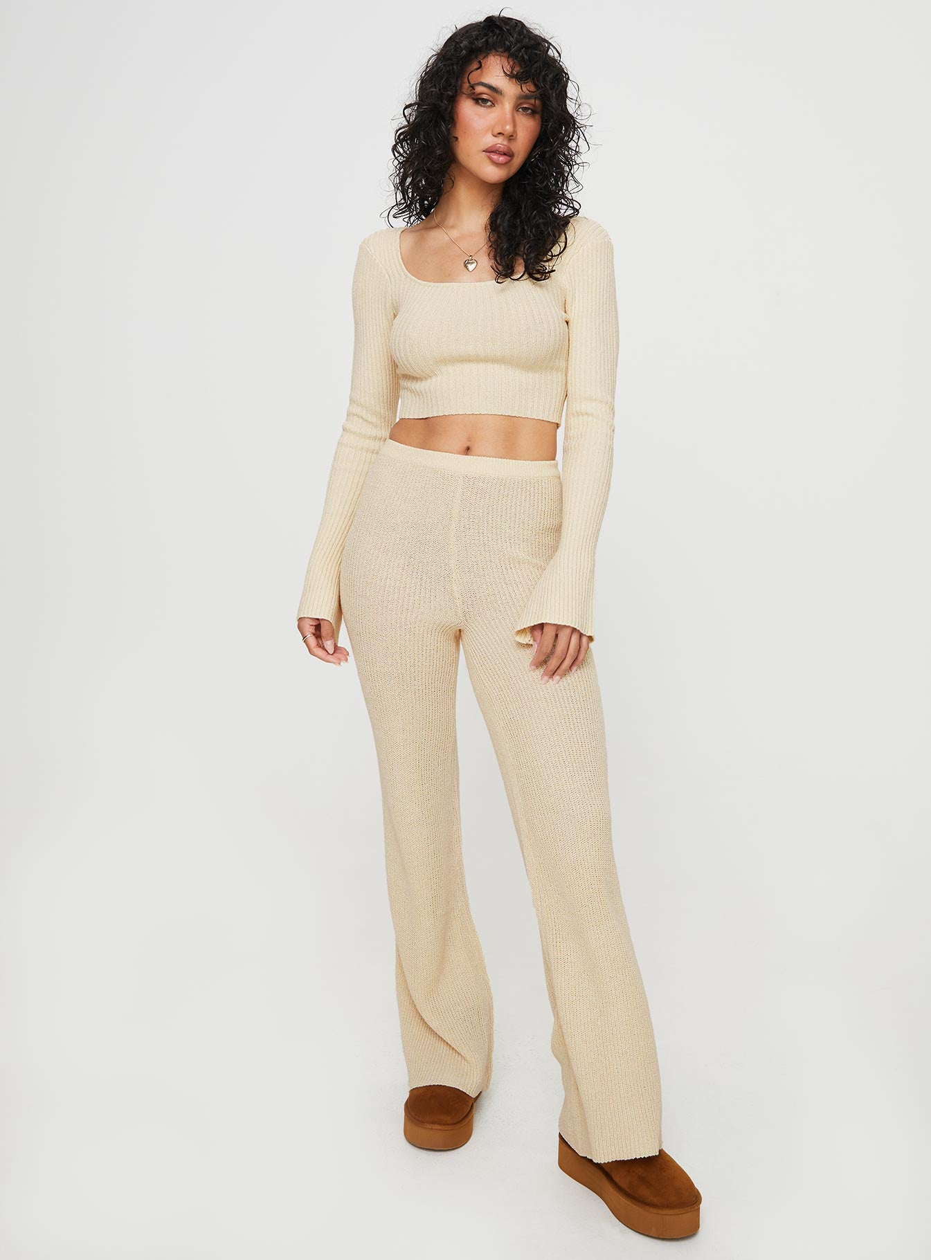 Knit set  Long sleeve crop style top, scoop neckline, flared sleeves, low back with cross fastening ties Mid-rise slightly flared pants, elasticated waistband  Good stretch, unlined