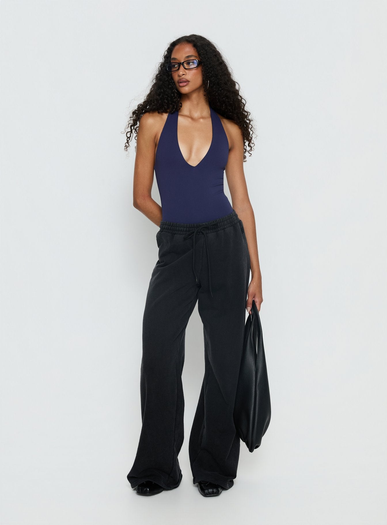 front view of model wearing Princess Polly Someone New Halter Bodysuit Navy Sleeveless 