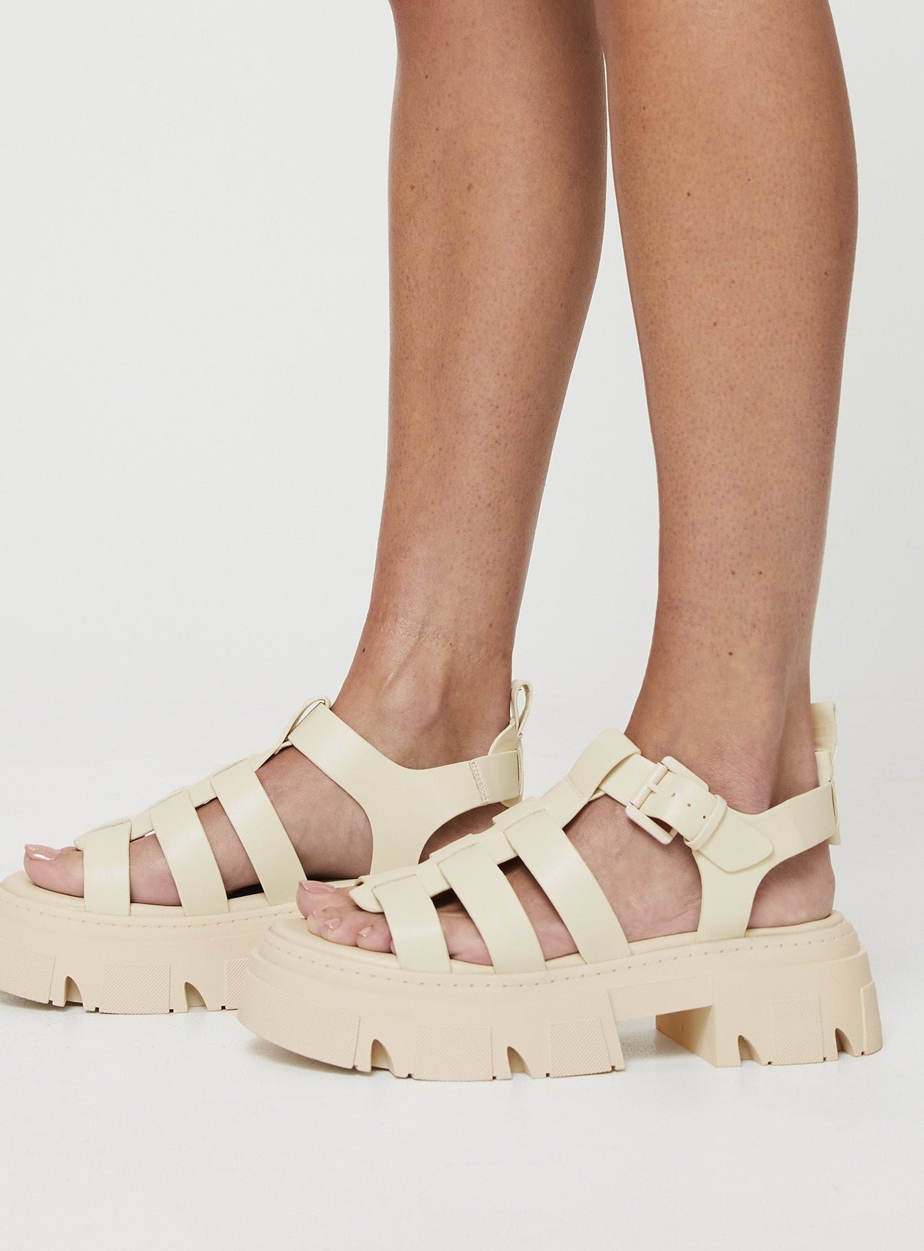 Strappy sandals Rounded toe, strappy upper, buckle fastening at ankle, platform base, treaded sole