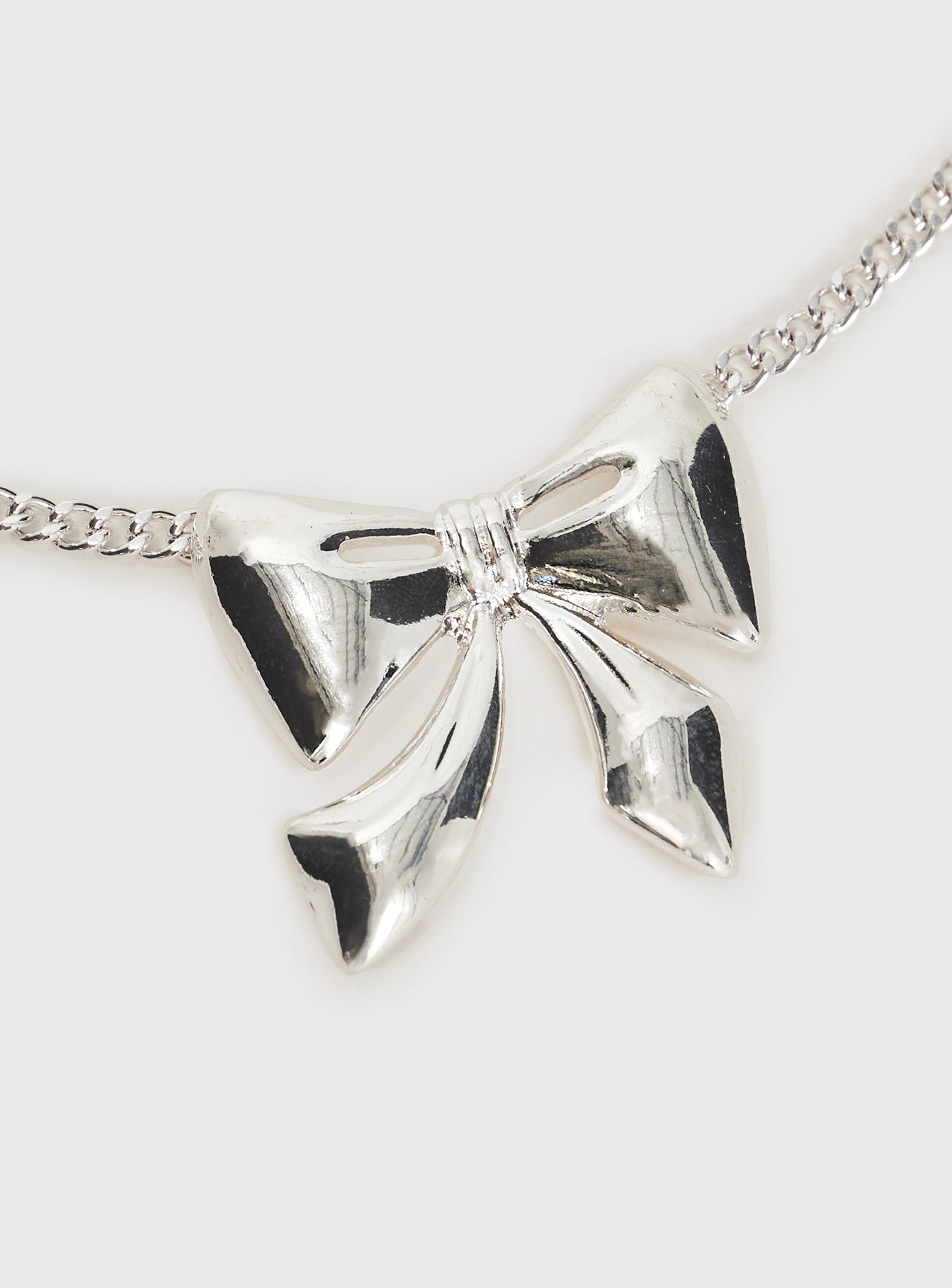 Silver-toned necklace Bow charm, lobster clasp fastening